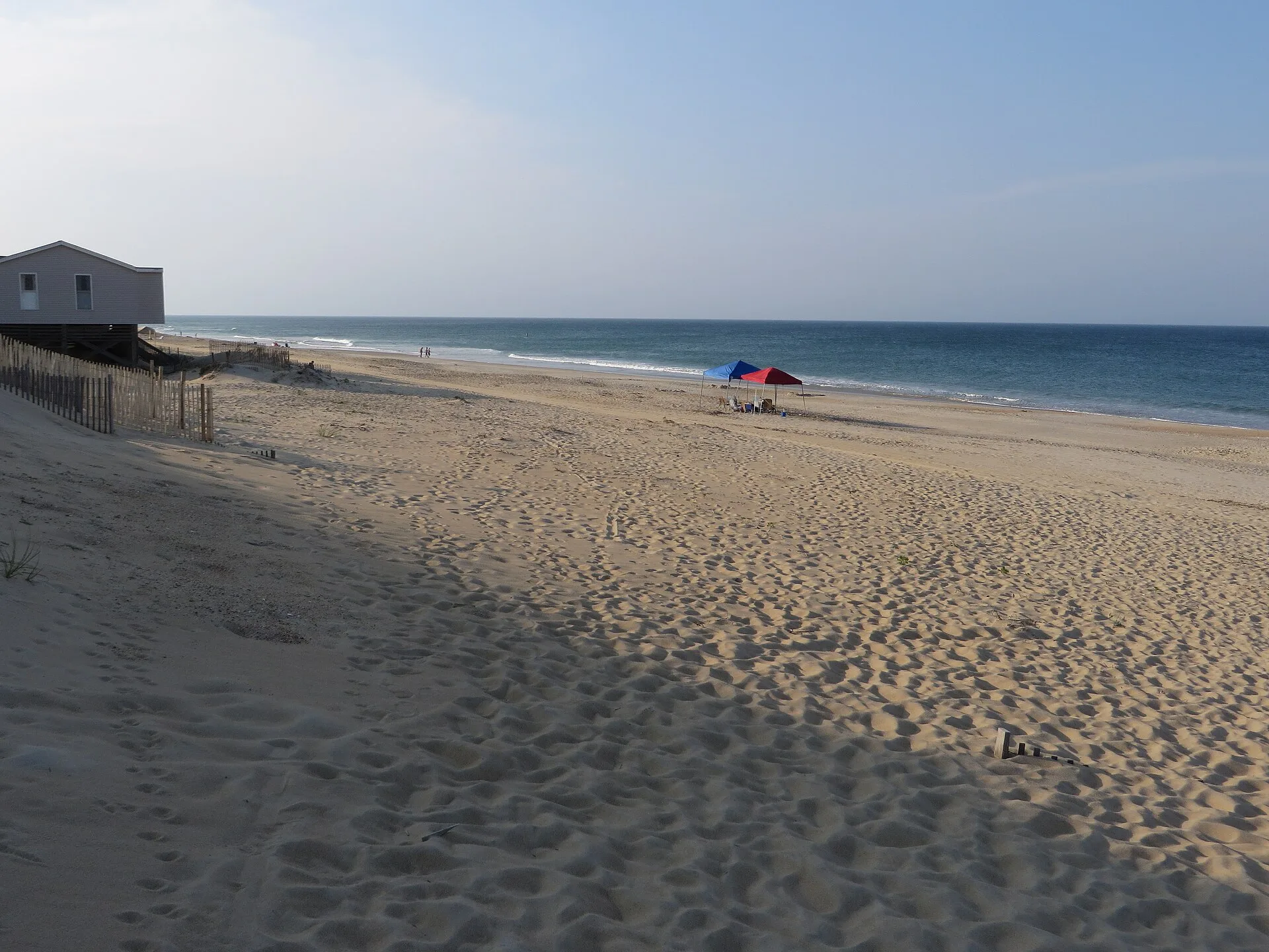 A wide Atlantic beach with a beach house on the Outer Banks, North Carolina