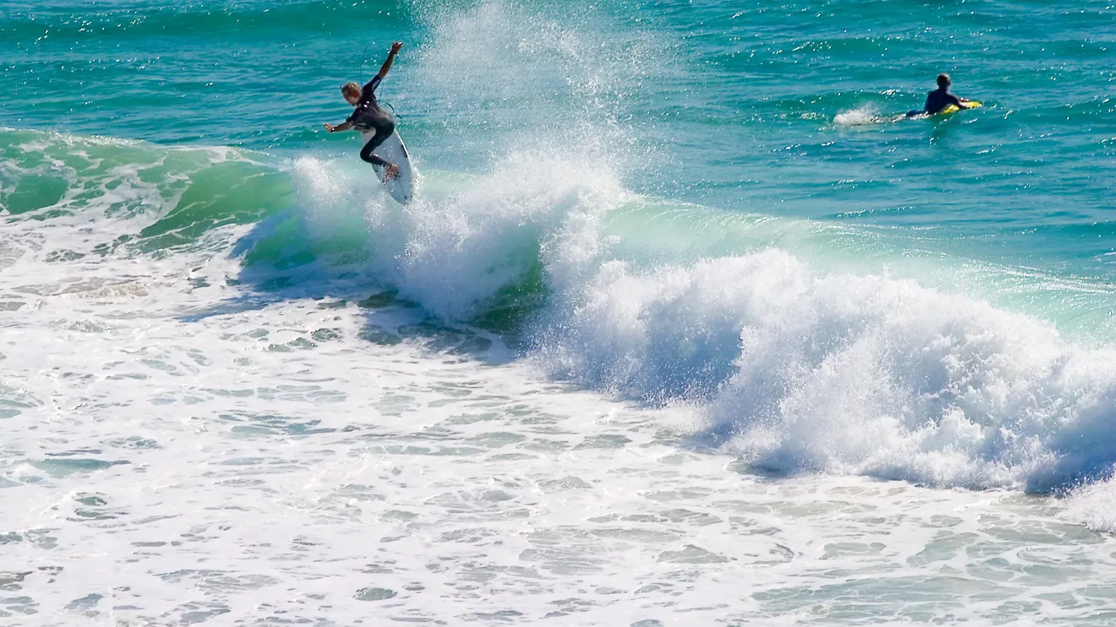 A surfer carving a breaking wave at Snapper Rocks on Australia's Gold Coast, a hub for active beach living